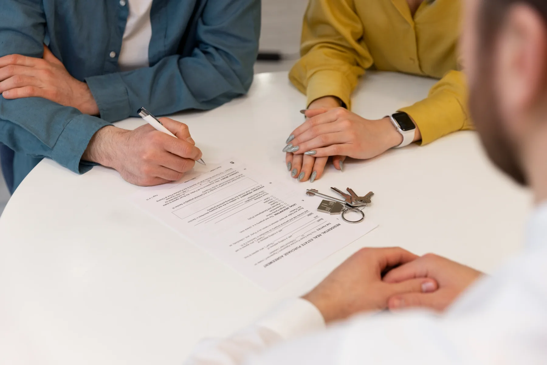 A property manager and prospective tenant reviewing a rental application at a leasing office.